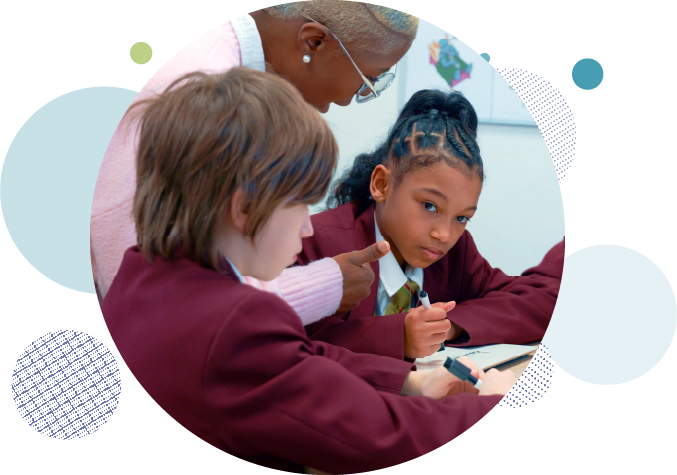 Two Key Stage 3 children, one boy and one girl, plus a teacher in a classroom during a phonics intervention lesson.
